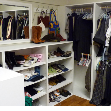 A walk-in closet full of clothes