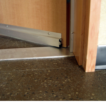 A door equipped with a tight-sealing bottom to control sound transmission.