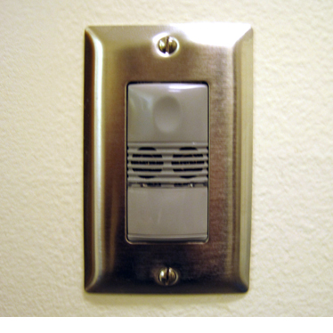 A light switch with an integrated occupancy sensor to turn off lights when the room is empty.