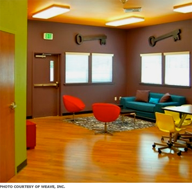 A bright room with spaces for teens to sit and hang out.